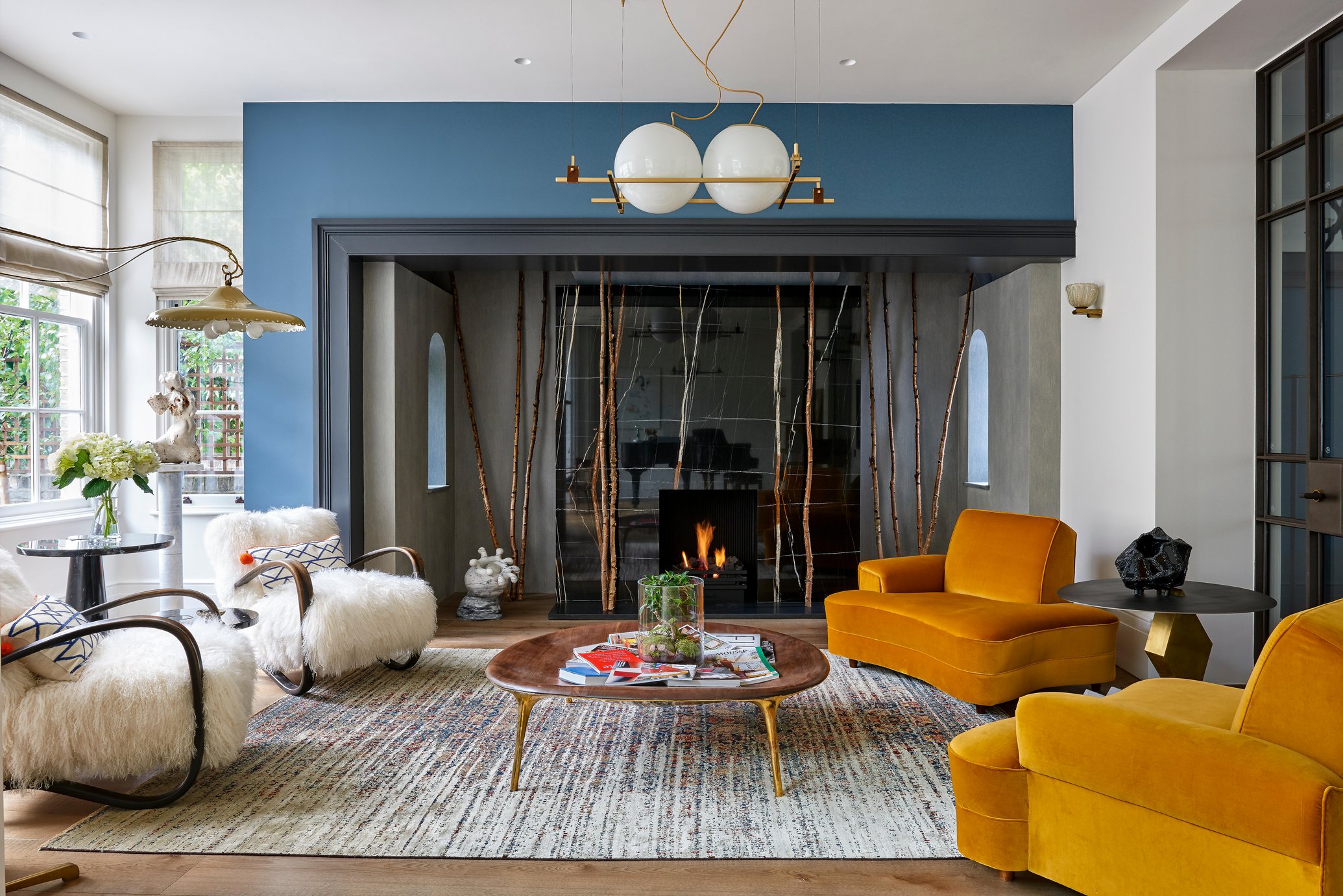 Cozy room with sheepskin covered chairs, wood table and amber colored chaises