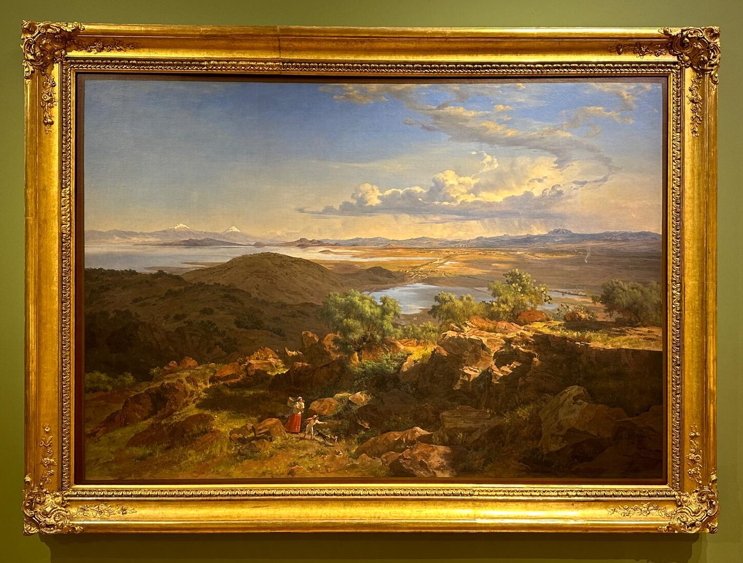 Gilt framed painting by Jose Maria Velasco of a rural landscape with a woman and a child